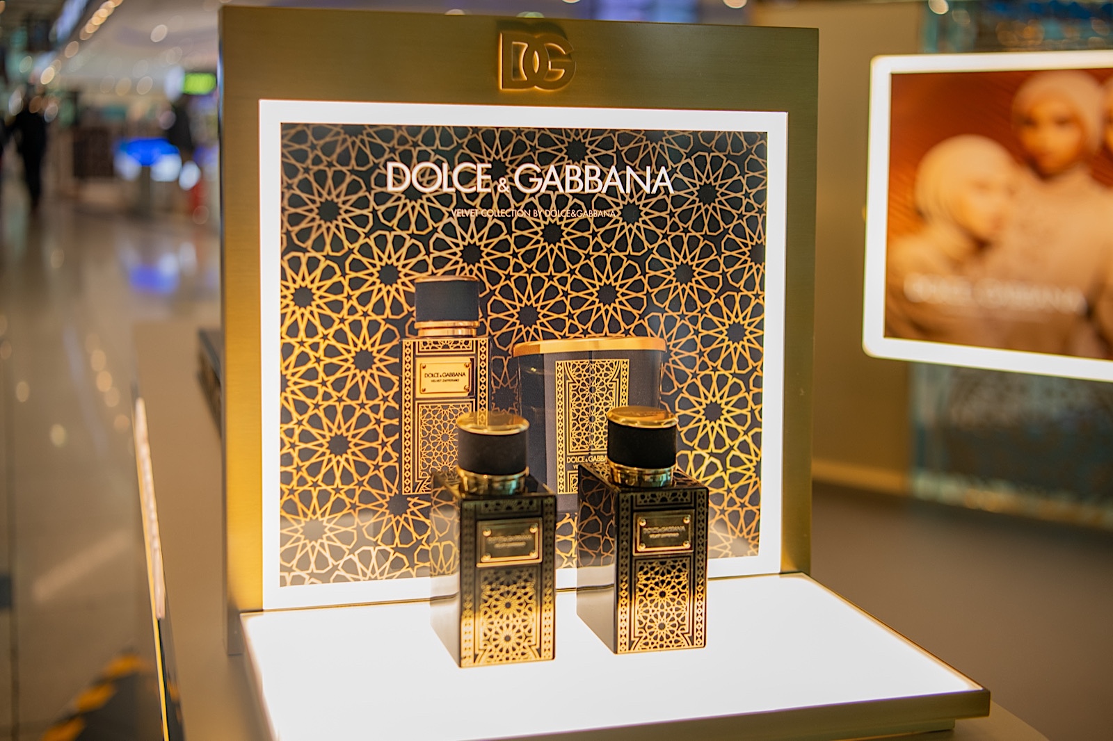 Luxury fragrance display lit on a stand in an airport duty-free hall